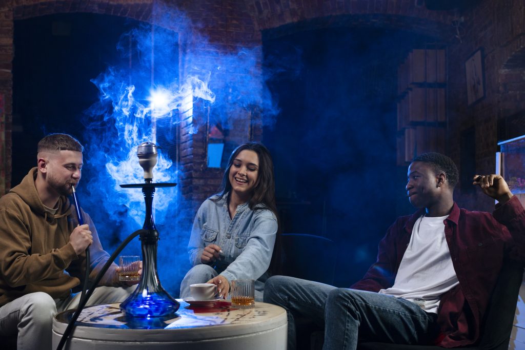 Hookah Lounge. Best Lounge in Toronto, Canada. Eden Lounge. Dim room with three people enjoying hookah session.